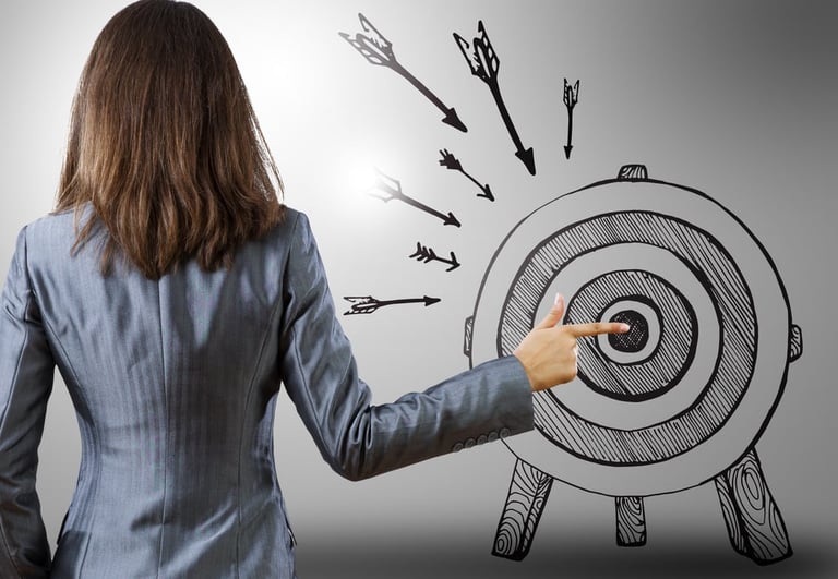 Rear view of businesswoman pointing at drawn target-1